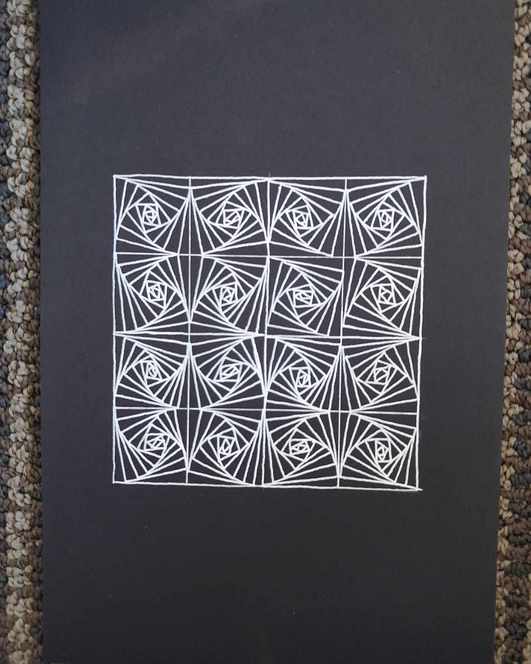 Repeating pattern zentangle in white gel pen.